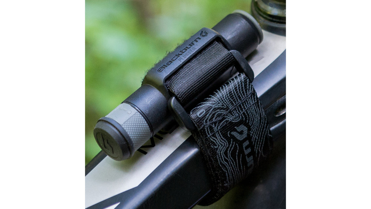 De Blackburn Plugger reparatieset stevig vastgemaakt aan de bovenbuis van een fiets met de meegeleverde strap.